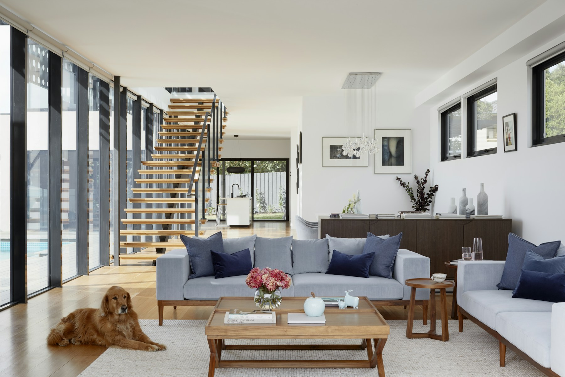 Bright modern living room with timber stair and garden view